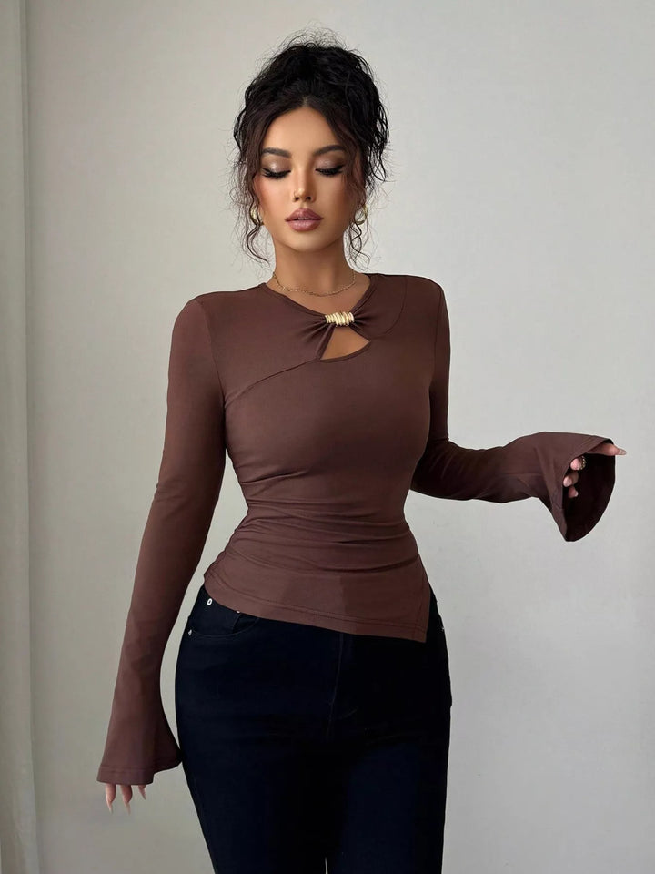 Cutout long sleeve top with gold ring and asymmetrical hem