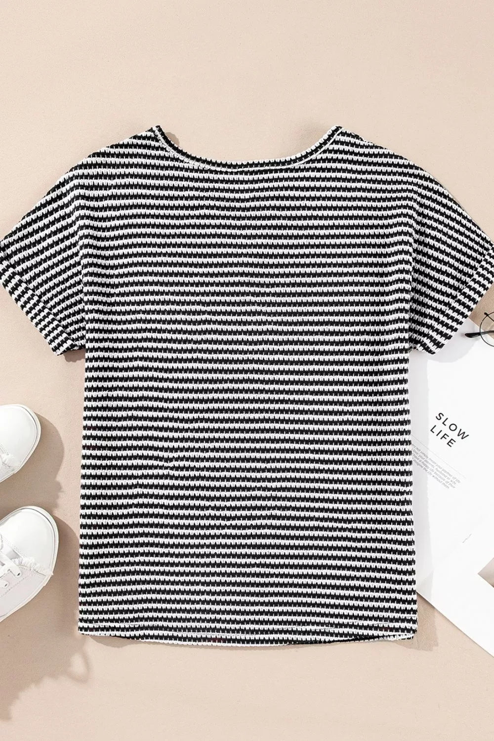 Striped textured knit top with notched V-neck and cuffed sleeves
