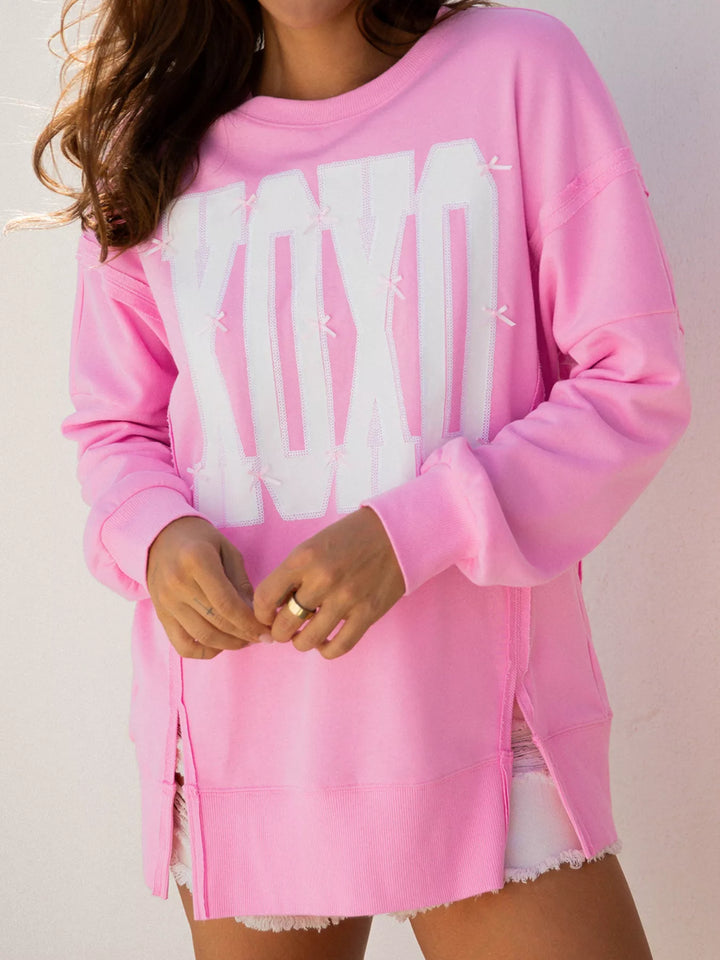 Pink Oversized XOXO graphic sweatshirt with exposed seams and bows