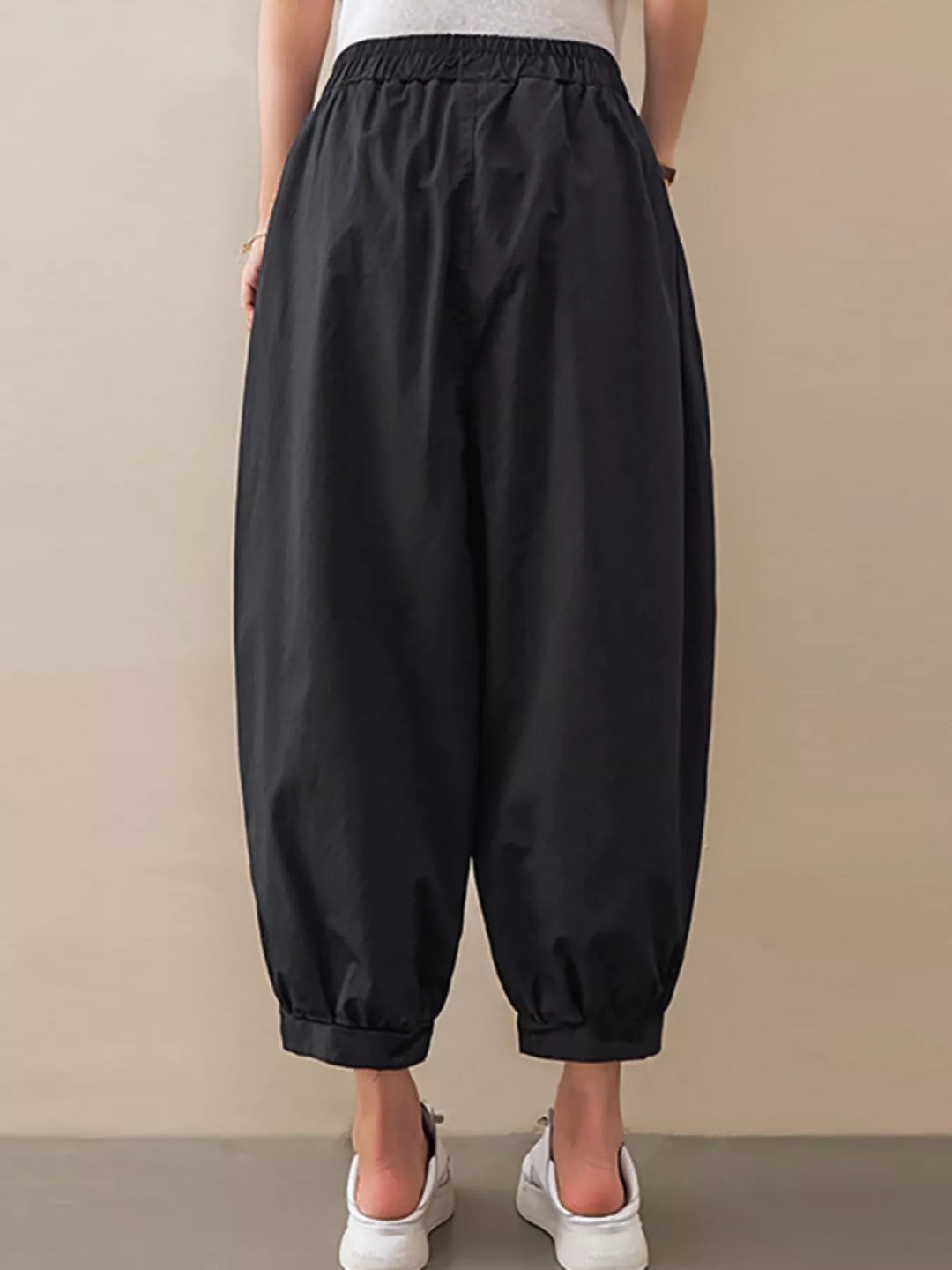 Pleated harem pants with elastic waist and tapered cuffs