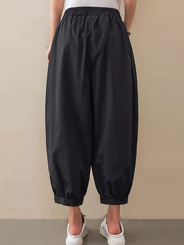 Pleated harem pants with elastic waist and tapered cuffs