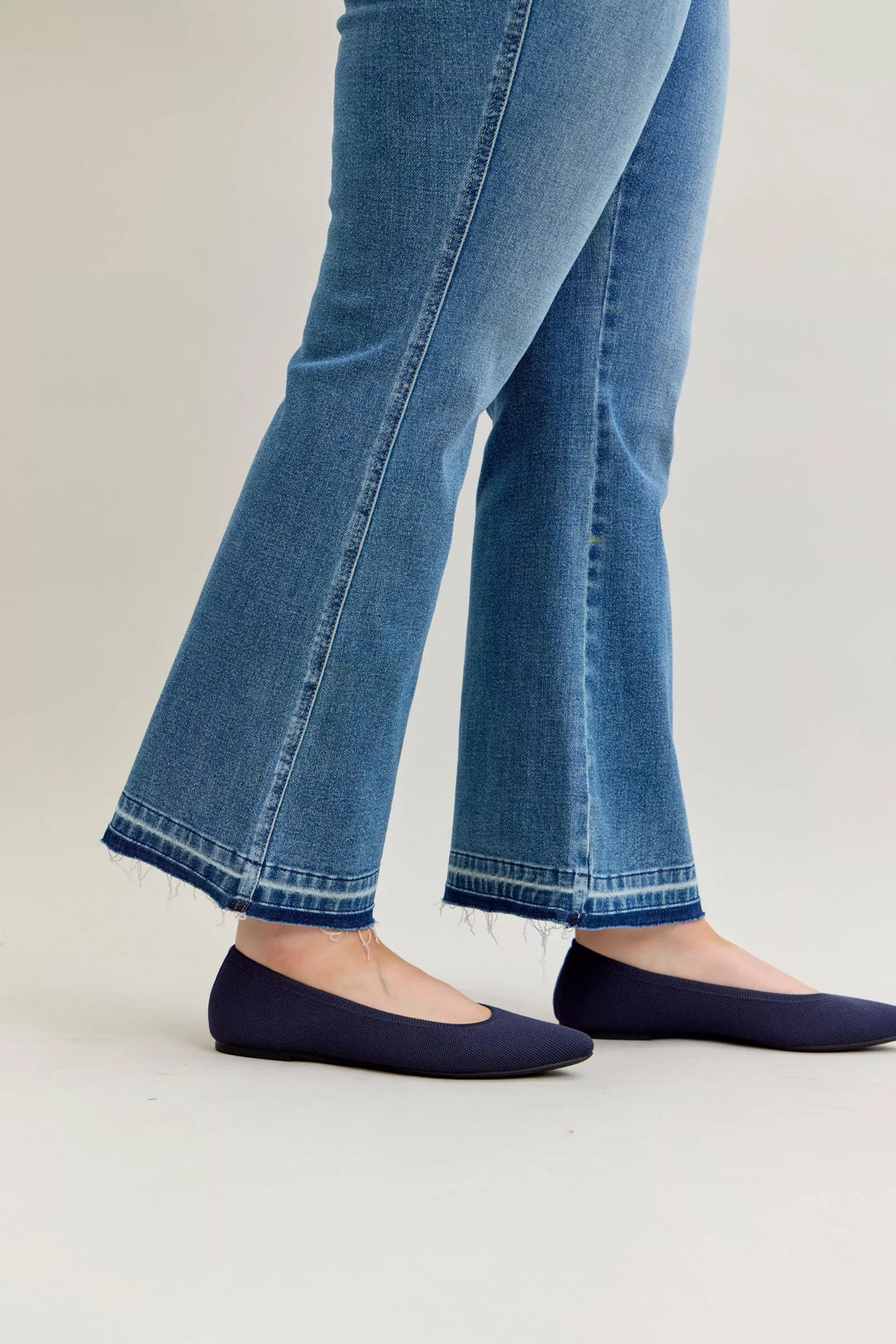 Mid-rise slim bootcut jeans with release hem and tummy control