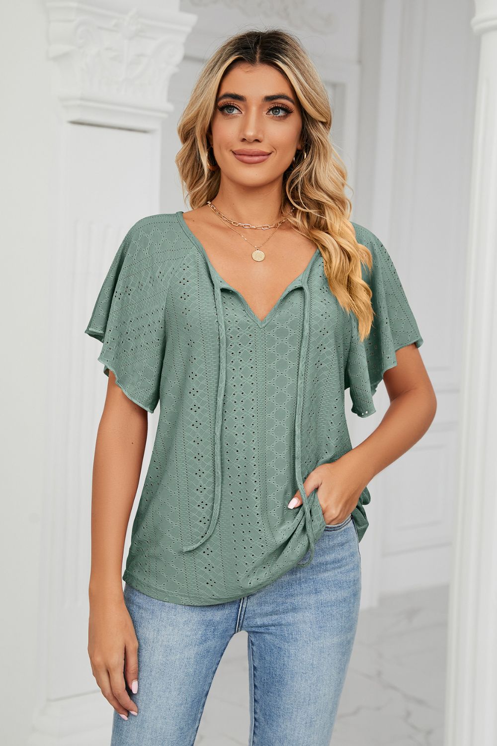 Eyelet flutter sleeve top with V-neck tie