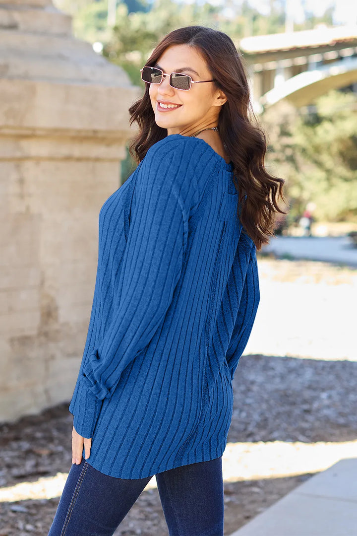 Ribbed knit round neck long sleeve top with curved hem