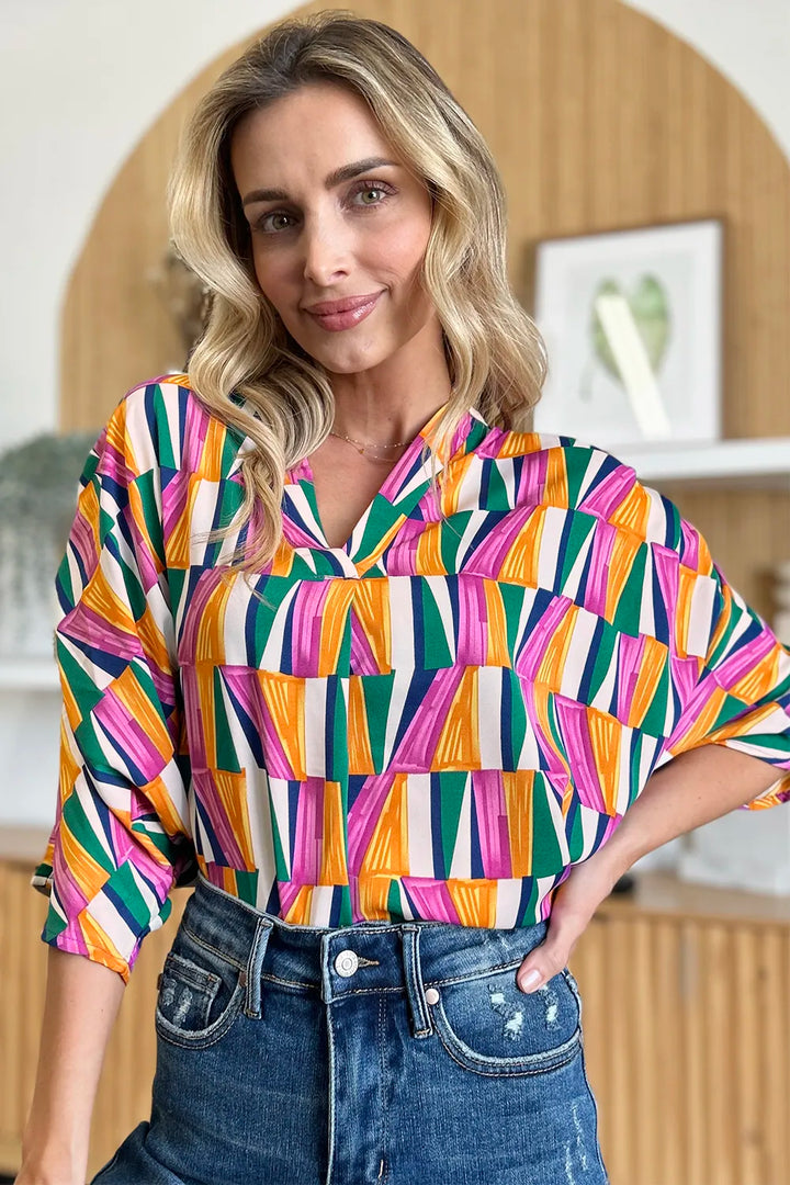 Geometric print notched neck dolman sleeve top