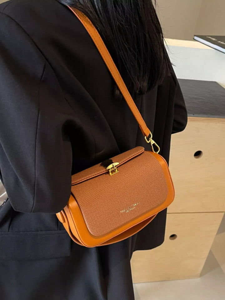 Structured boxy crossbody bag with gold clasp and top handle