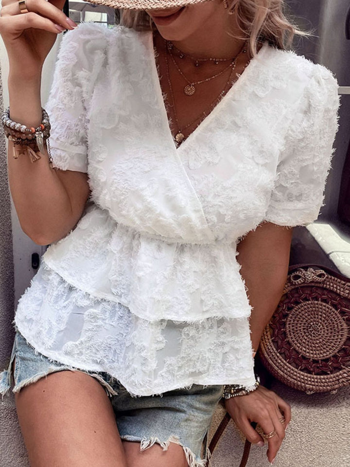 Textured surplice neck peplum top with puff sleeves