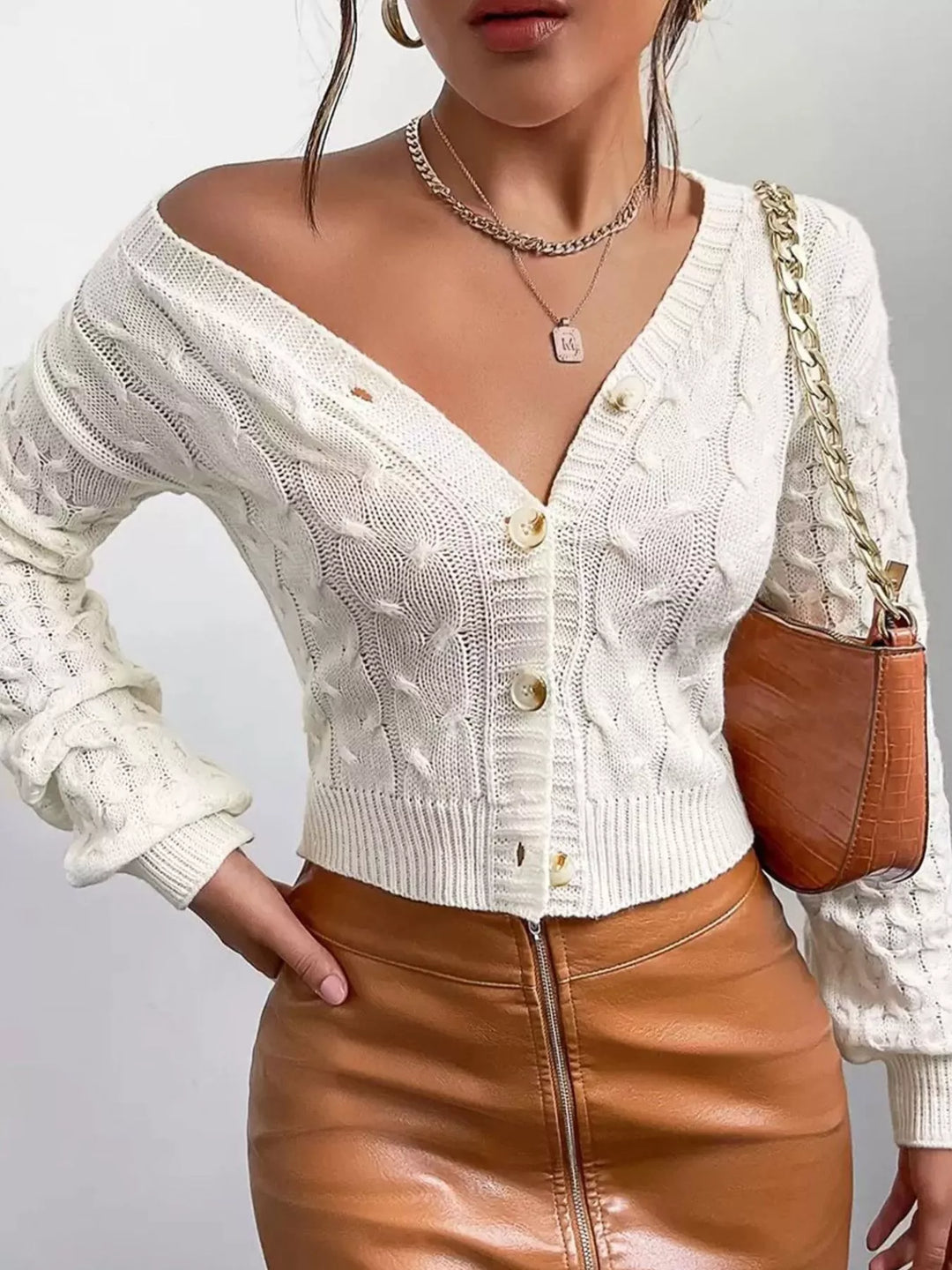 Cropped cable knit button-front cardigan with pointelle sleeves