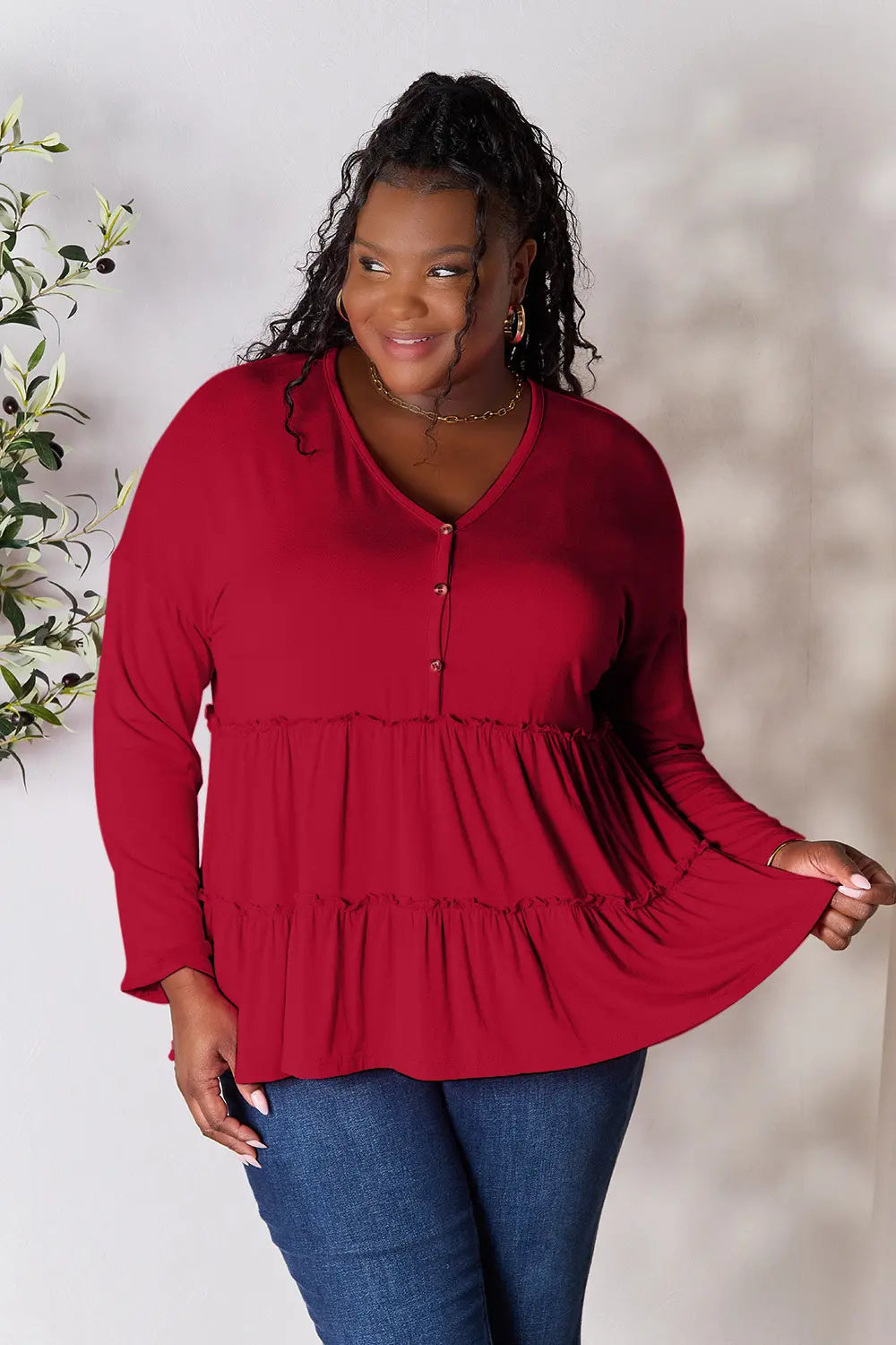 Half-button long sleeve blouse with tiered ruffle hem
