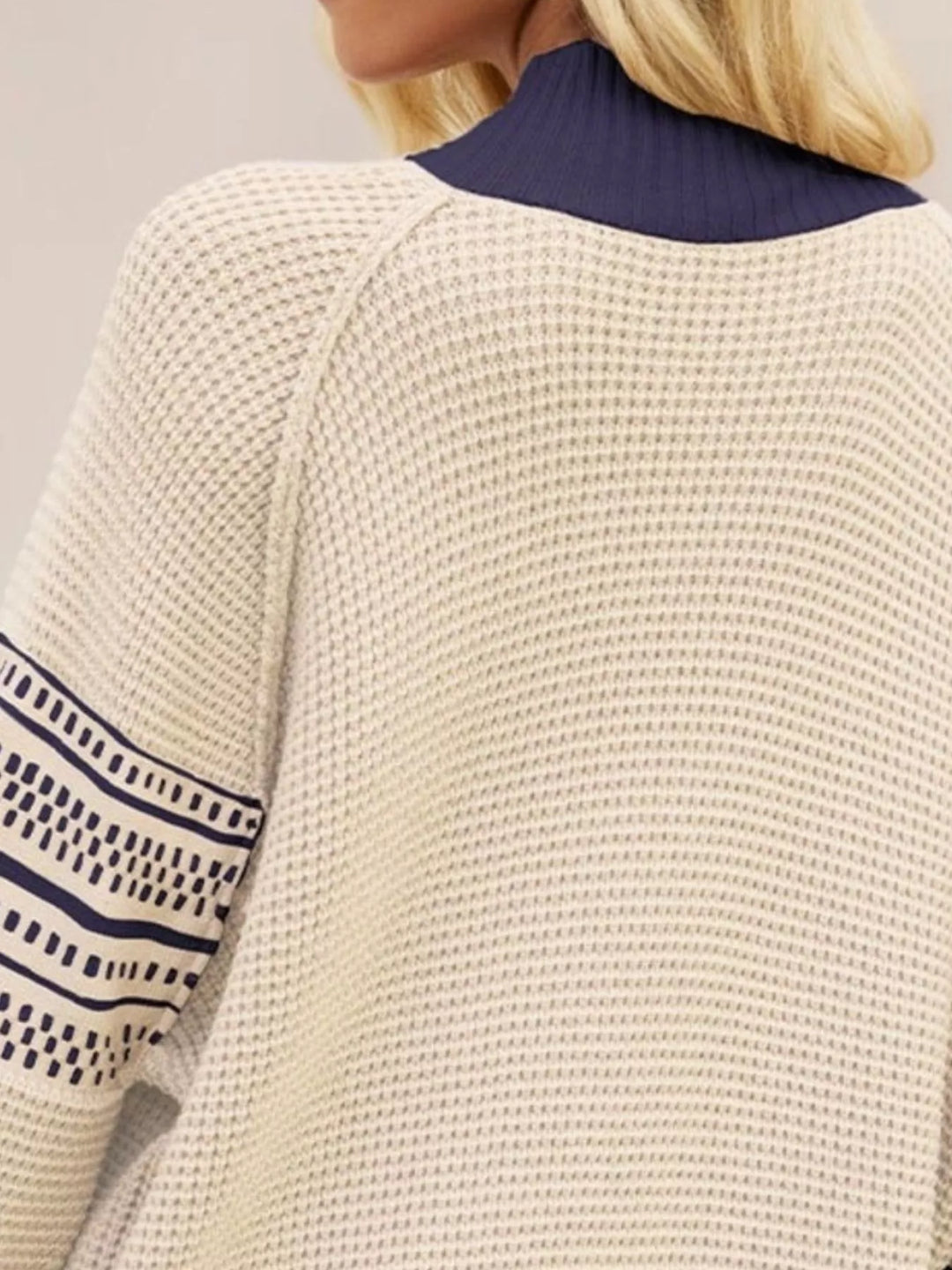 Waffle knit mock neck sweater with geometric sleeve stripes
