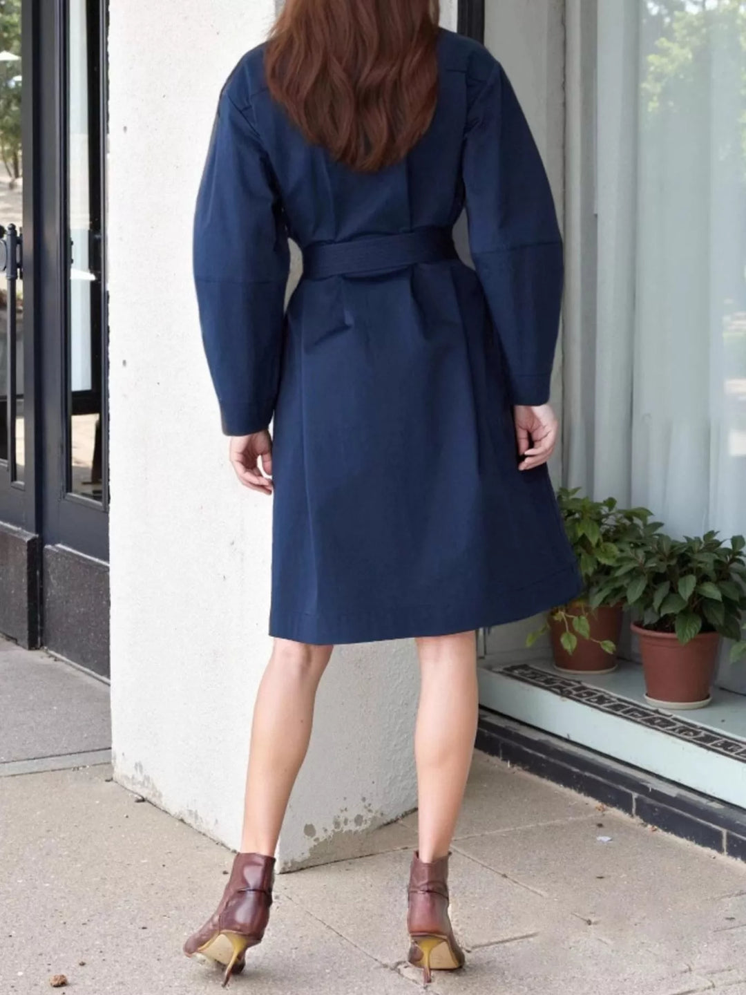Collarless double-breasted belted trench coat with gold buttons