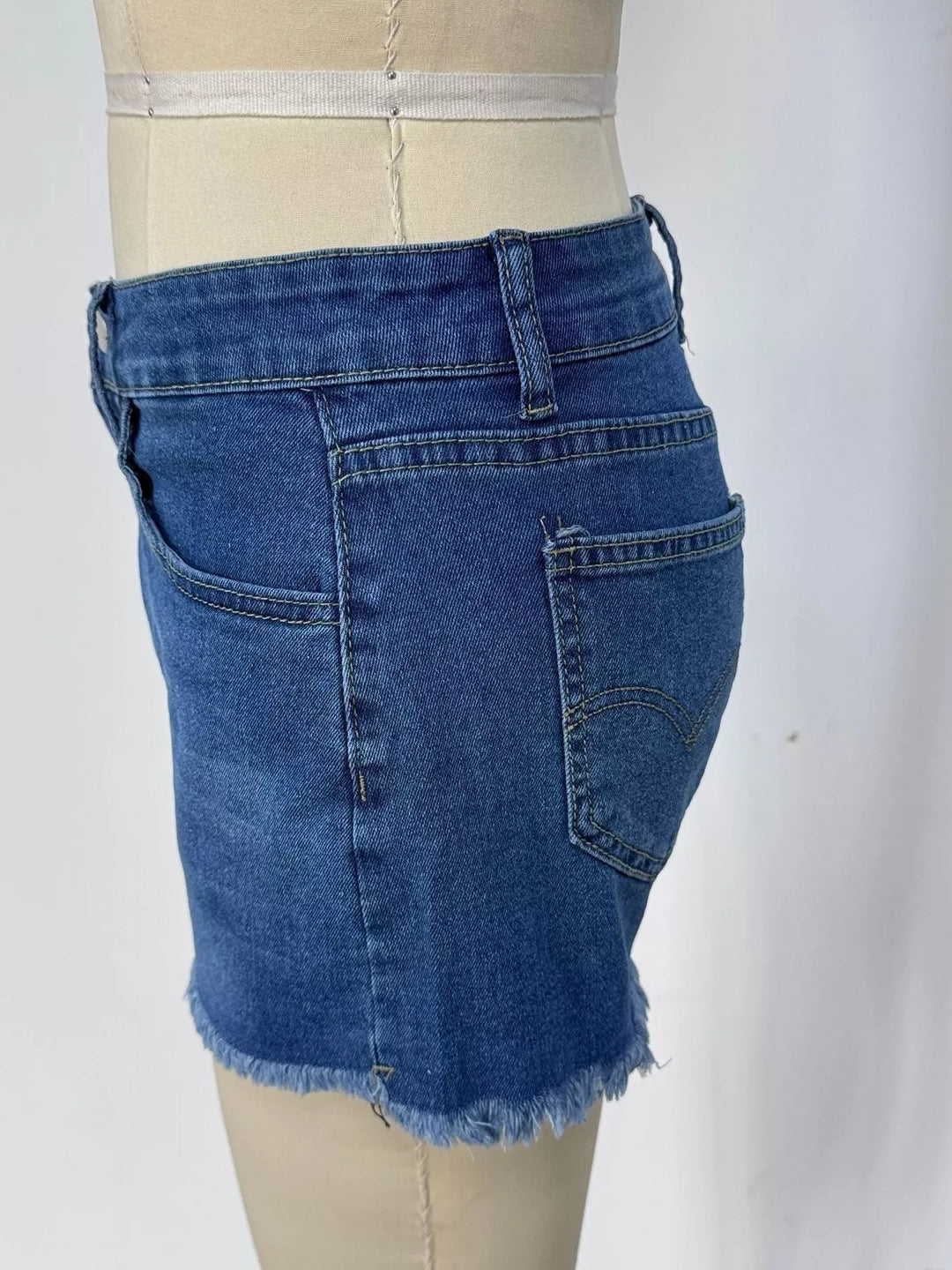 Raw hem denim shorts with frayed edges and five-pocket styling