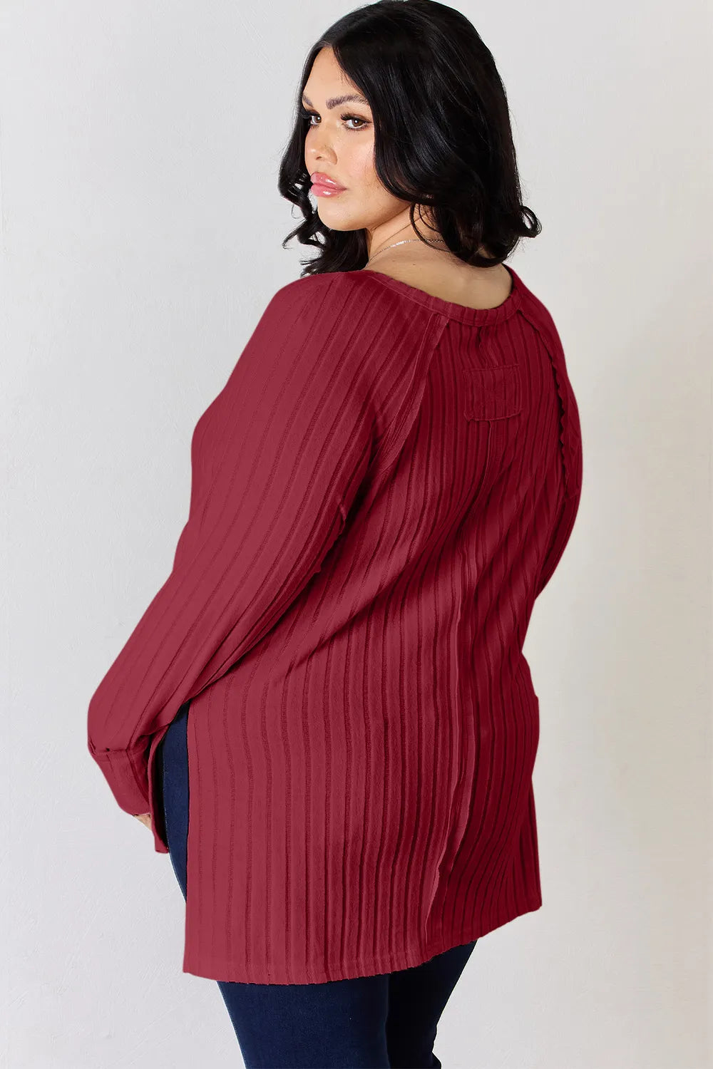 Ribbed knit round neck long sleeve top with side slits
