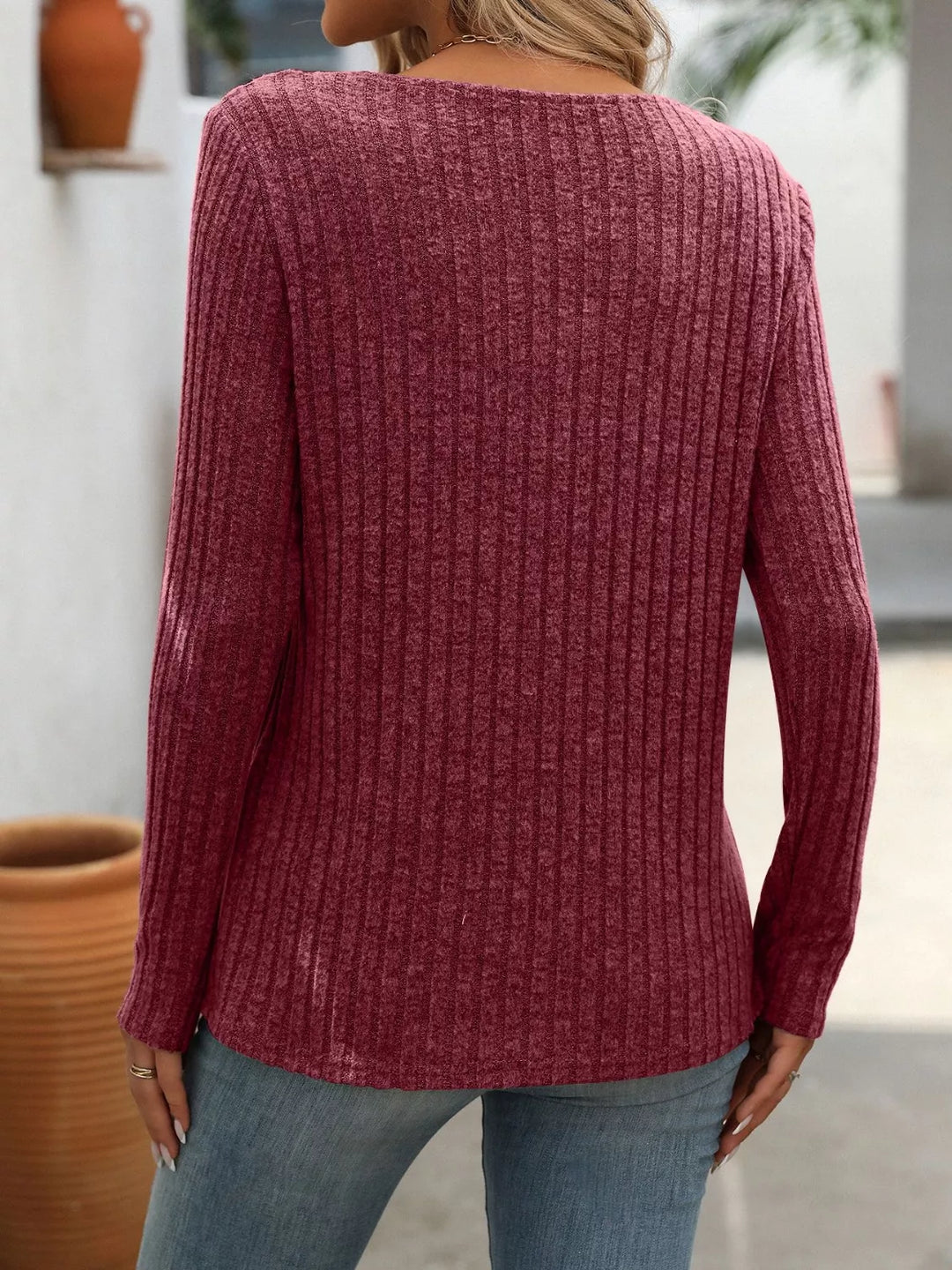 Ribbed knit long sleeve top with asymmetric button neckline