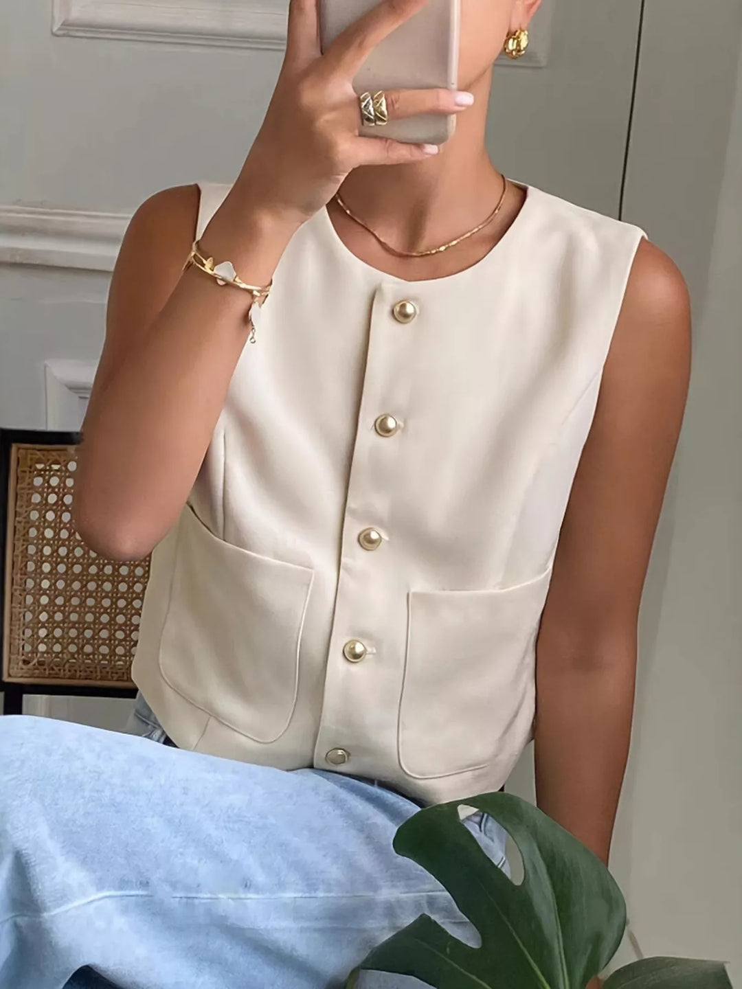 Button-down sleeveless vest with gold dome buttons and patch pockets