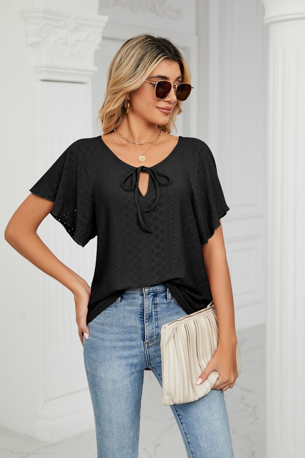Eyelet flutter sleeve top with V-neck tie