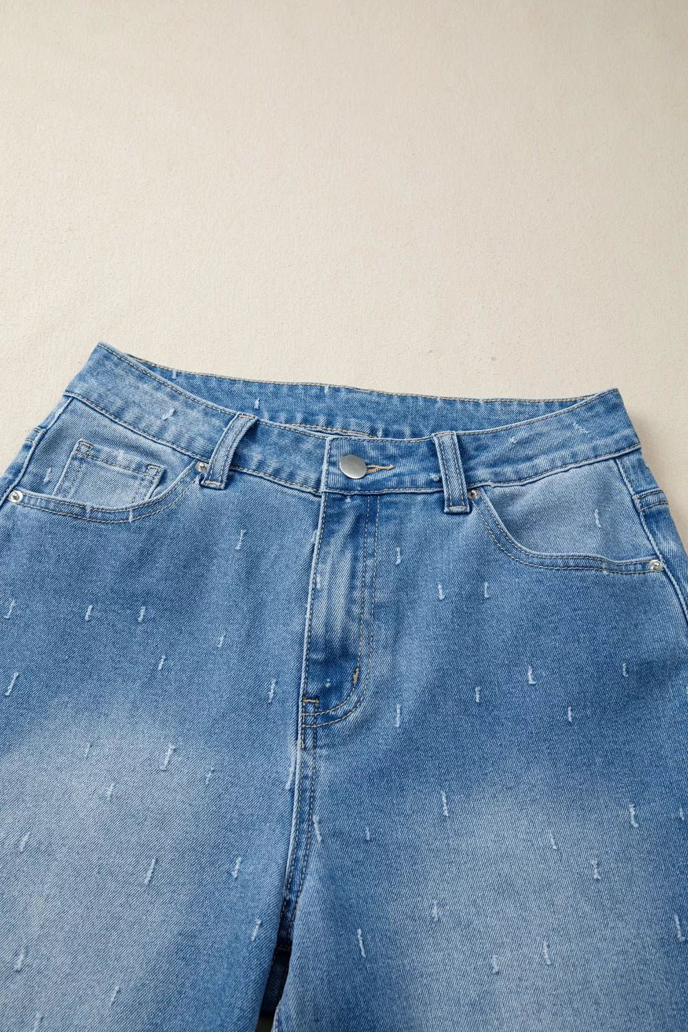 Distressed wide-leg jeans with tummy control and raw hem