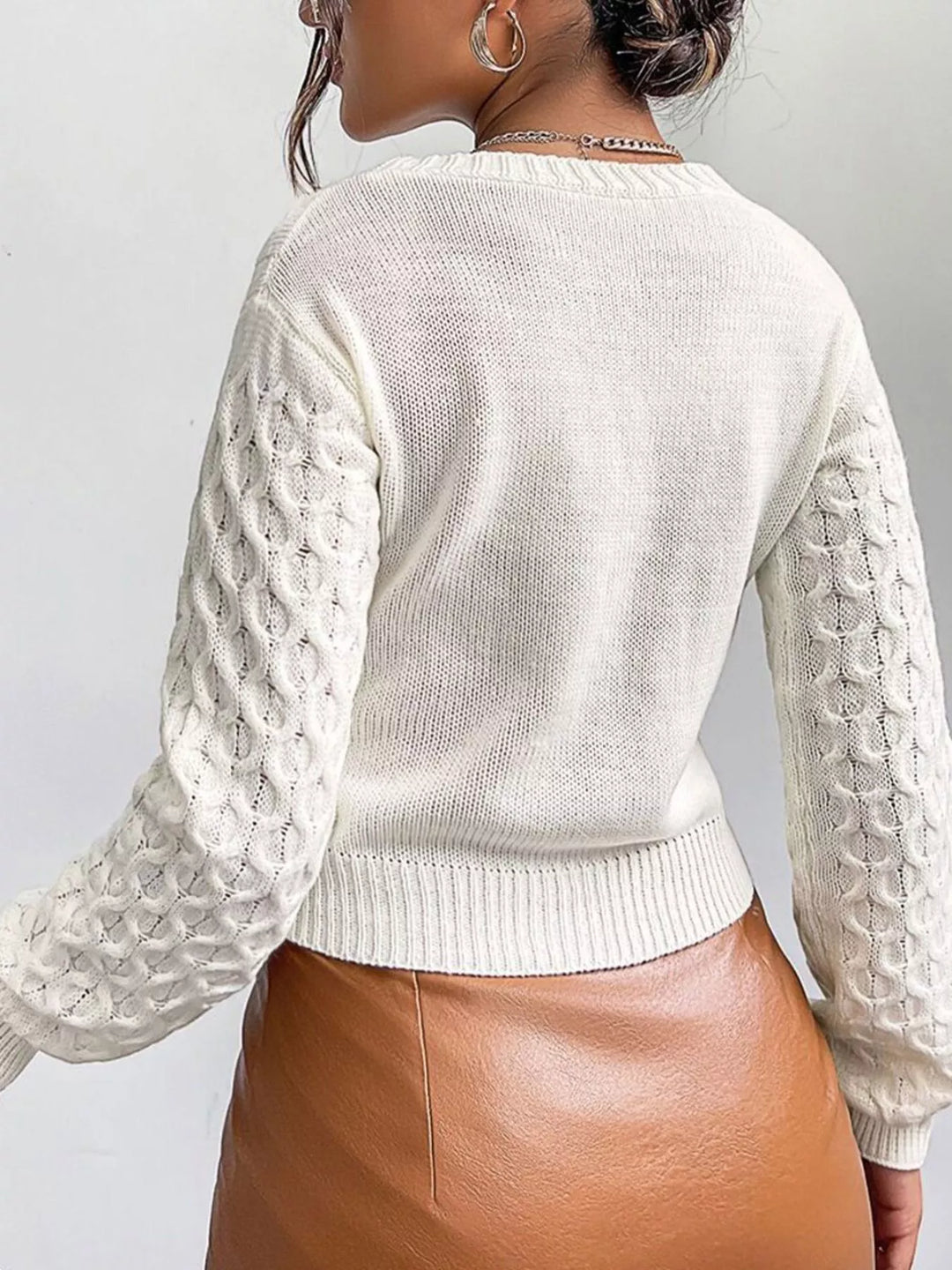 Cropped cable knit button-front cardigan with pointelle sleeves