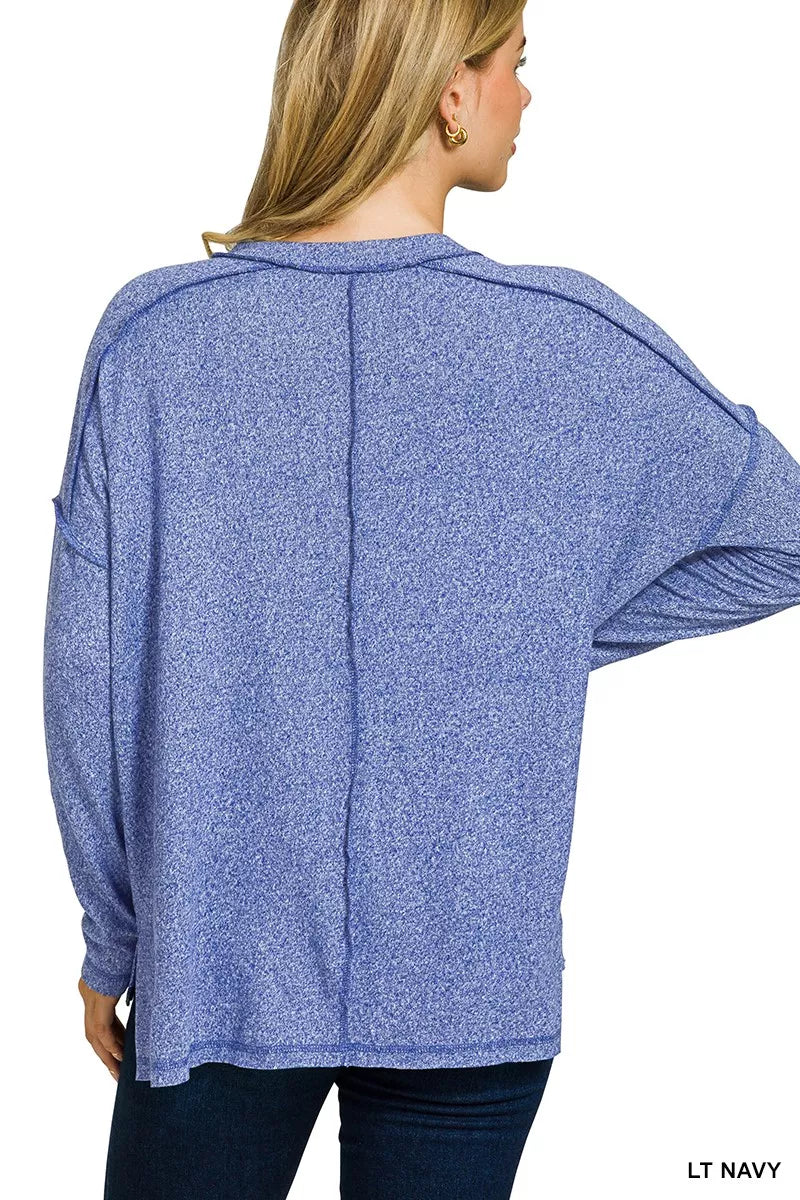 Exposed-seam melange knit hi-low long sleeve top