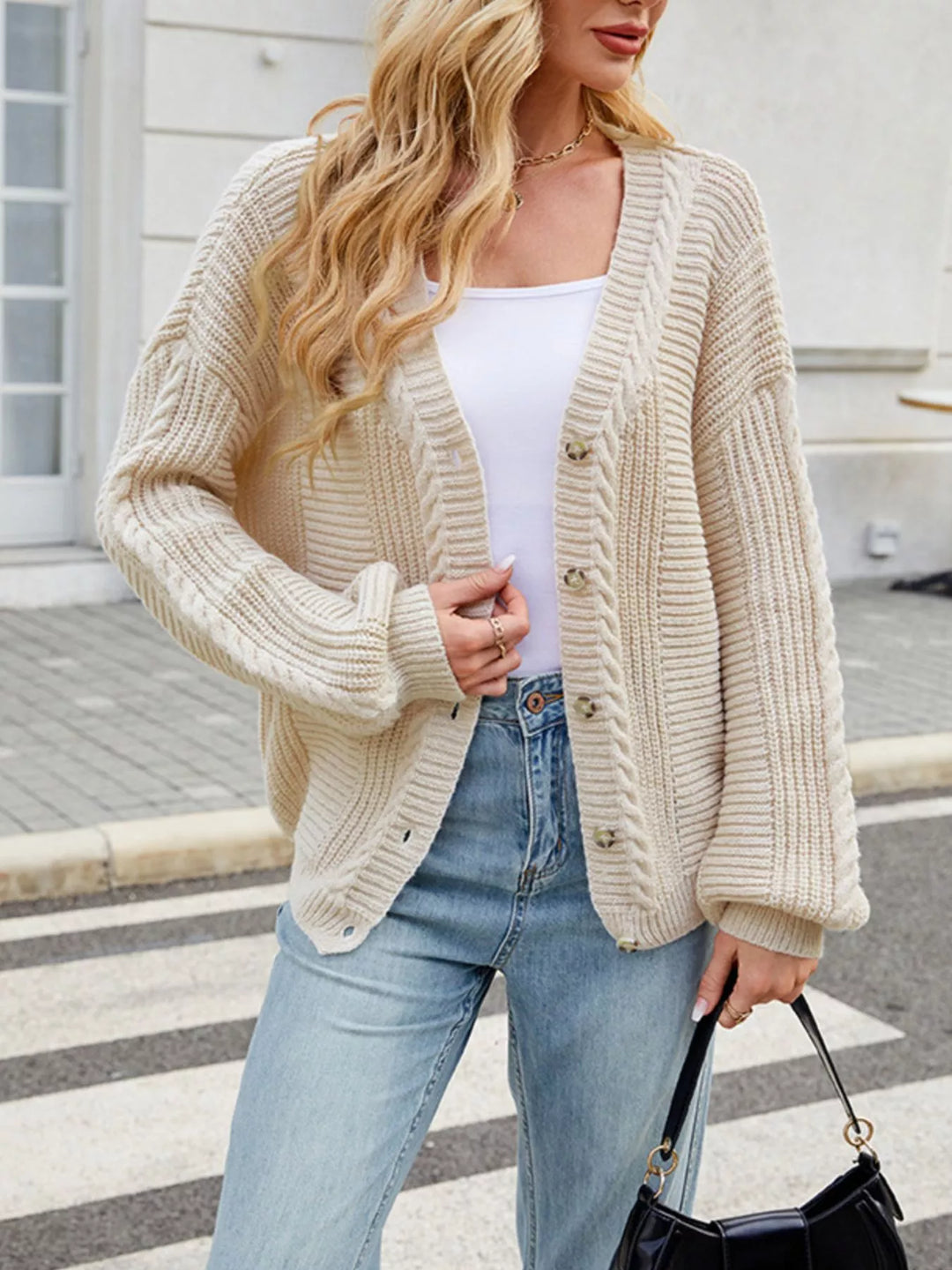 Cable knit button-front cardigan with drop shoulder sleeves