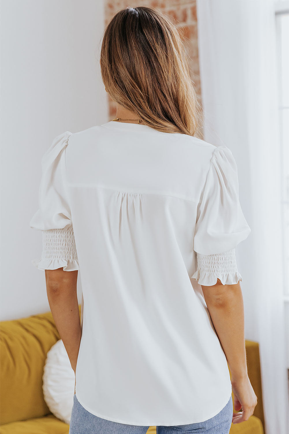Notched neck blouse with smocked flounce sleeves