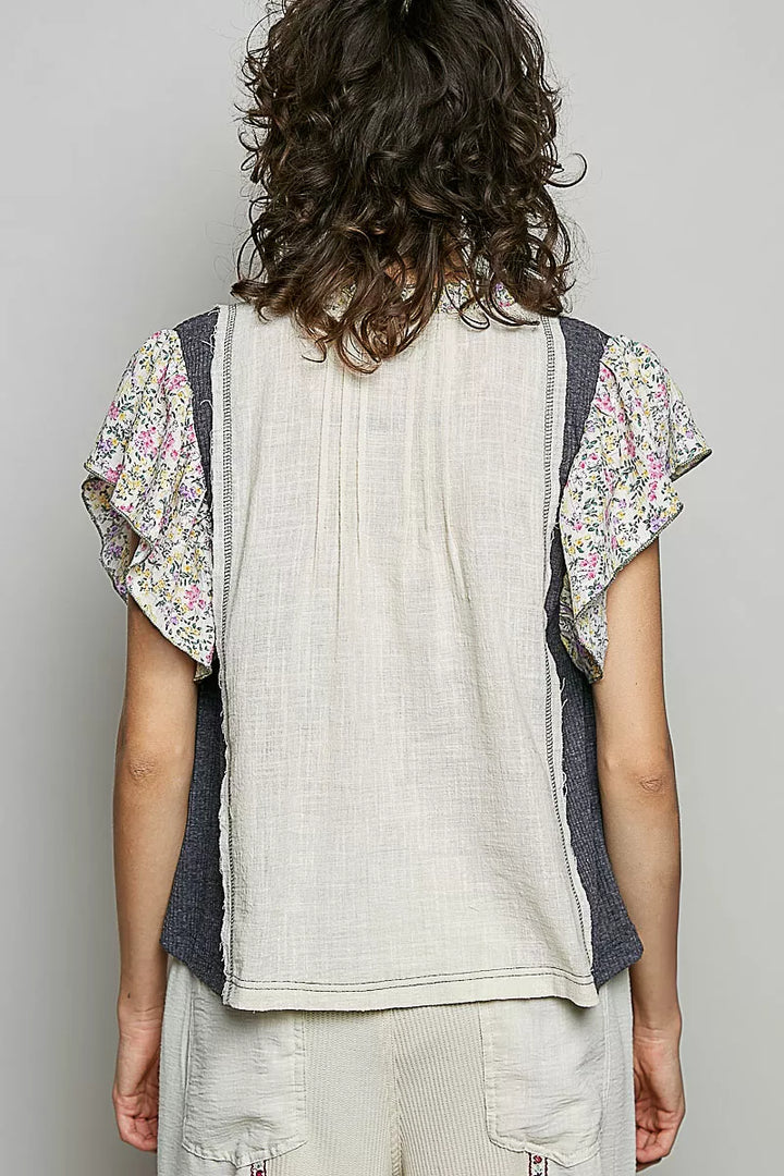 V-neck woven blouse with floral ruffle trim and pintuck front