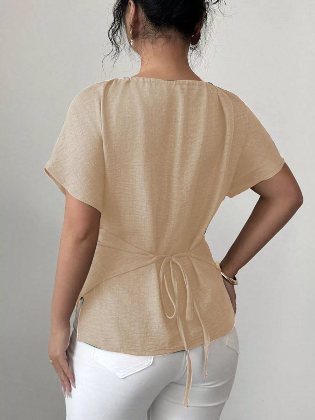Wrap-front short sleeve blouse with beaded keyhole neckline