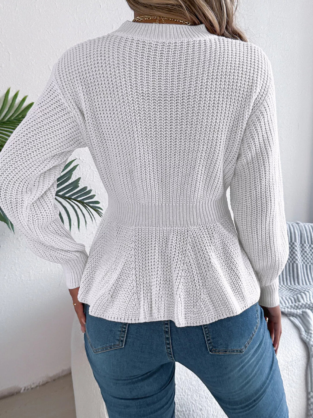 Cable knit peplum sweater with mock neck
