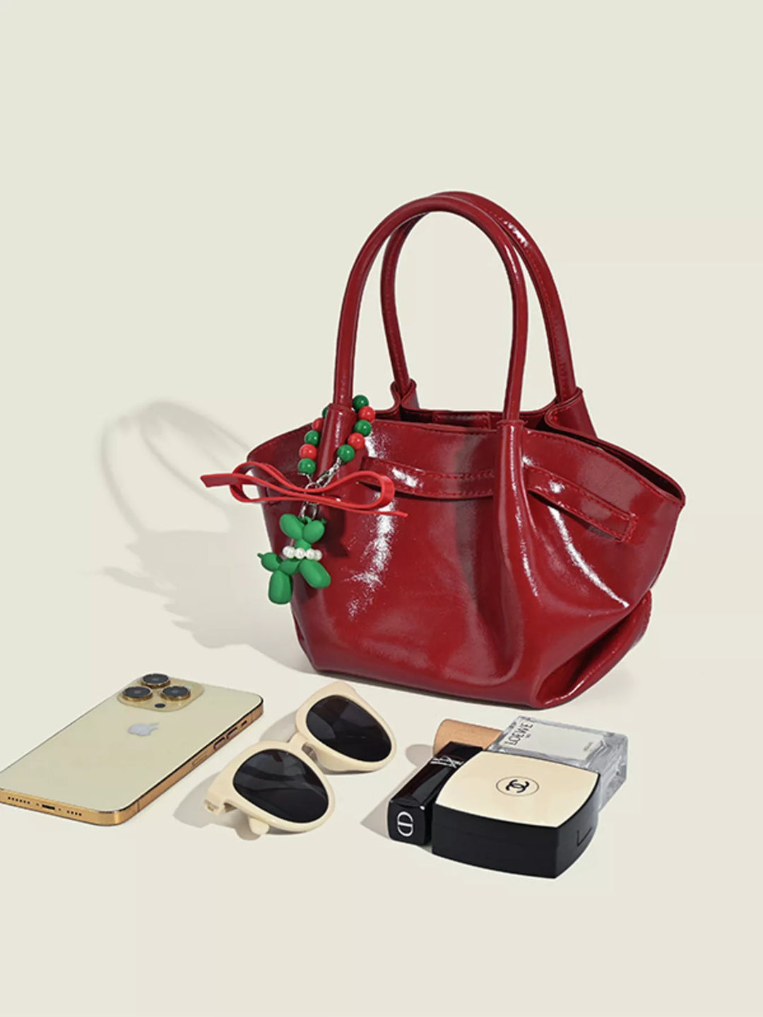 Glossy slouchy top handle crossbody bag with beaded charm