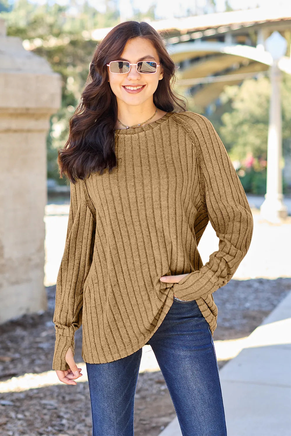 Ribbed knit round neck long sleeve top with curved hem