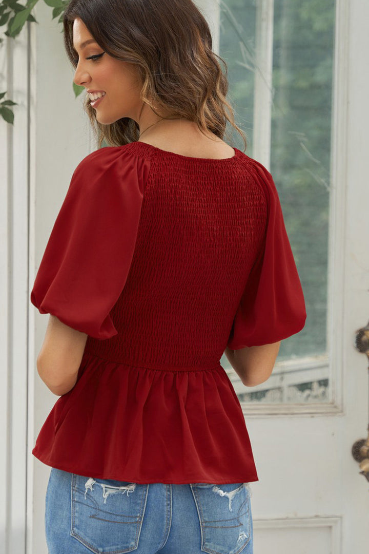 Smocked peplum blouse with balloon sleeves and V-neck