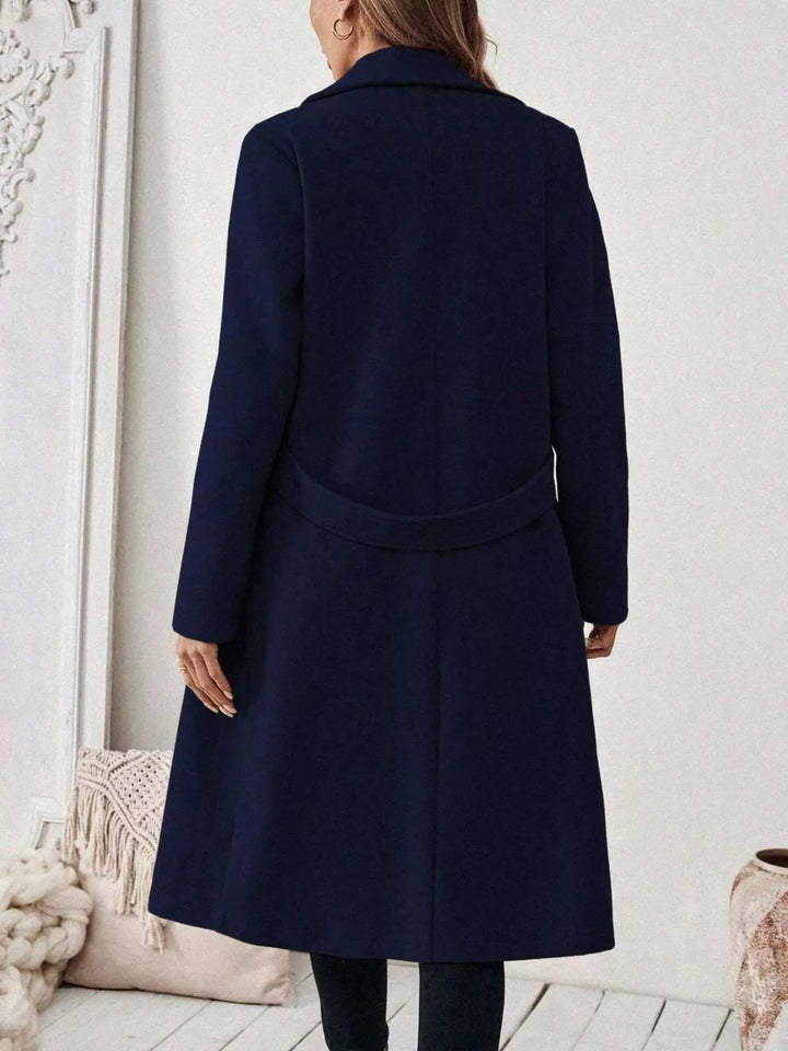 Longline notch lapel coat with single-button waist tab