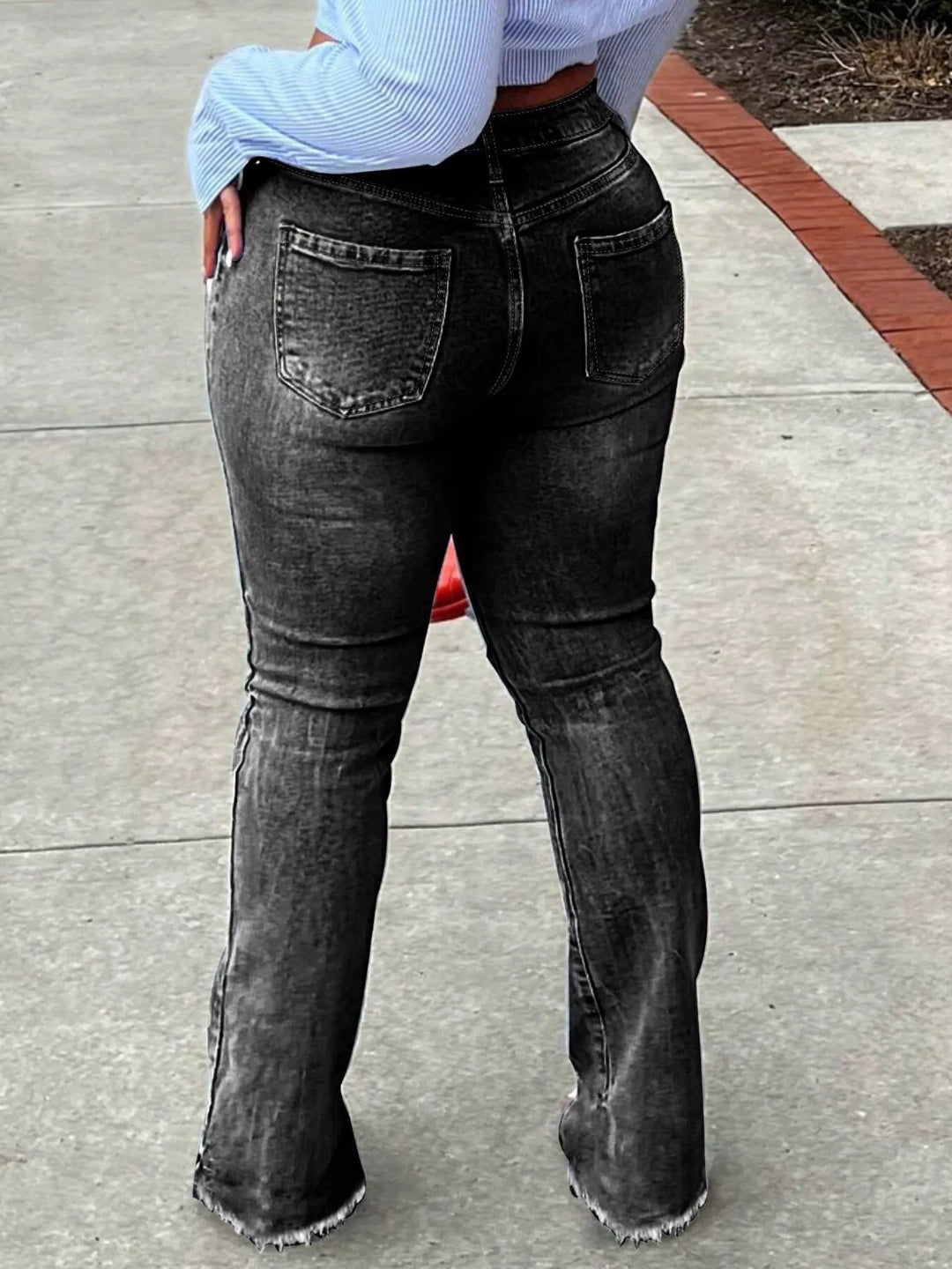 High-rise ripped knee flare jeans with raw hem