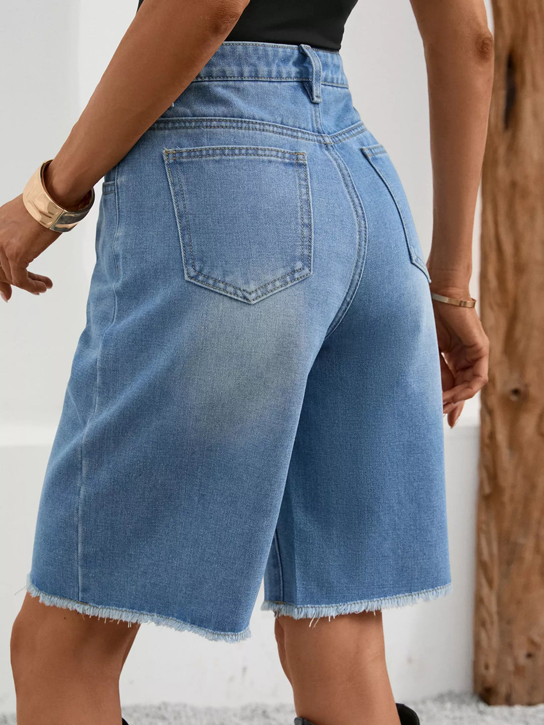 Distressed high-rise denim bermuda shorts with frayed hem