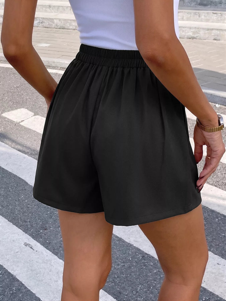 Pleated high-rise shorts with wrap waist and rose button