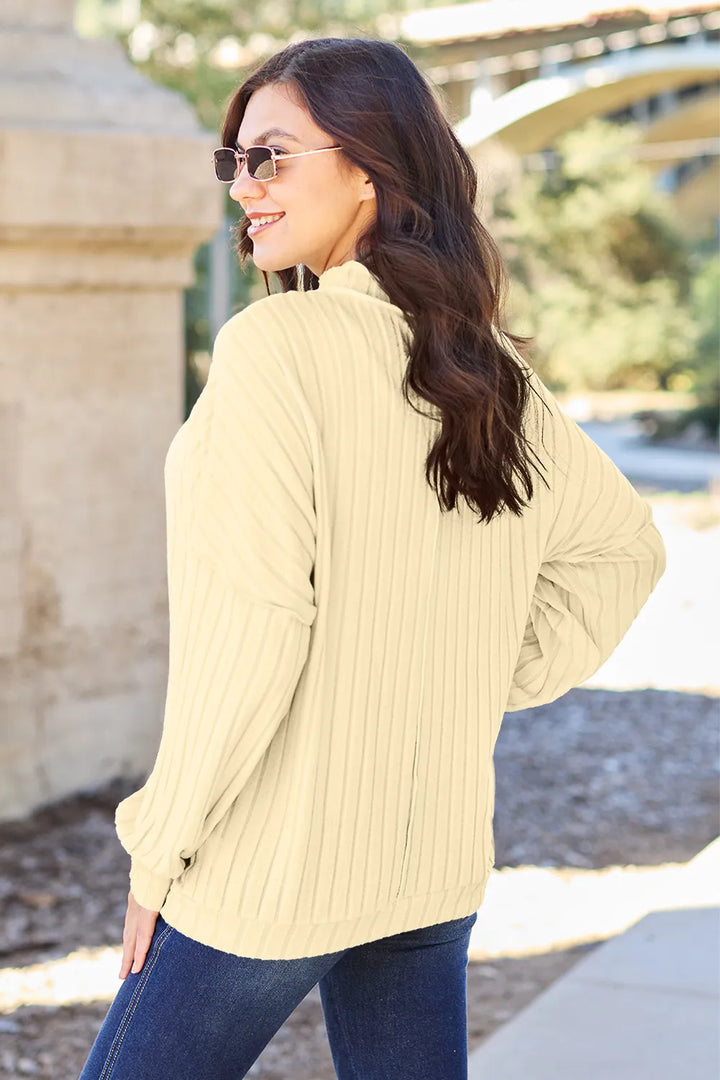 Ribbed exposed-seam mock neck knit top with drop shoulders