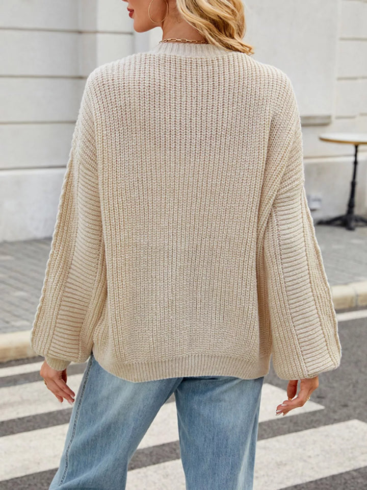 Cable knit button-front cardigan with drop shoulder sleeves
