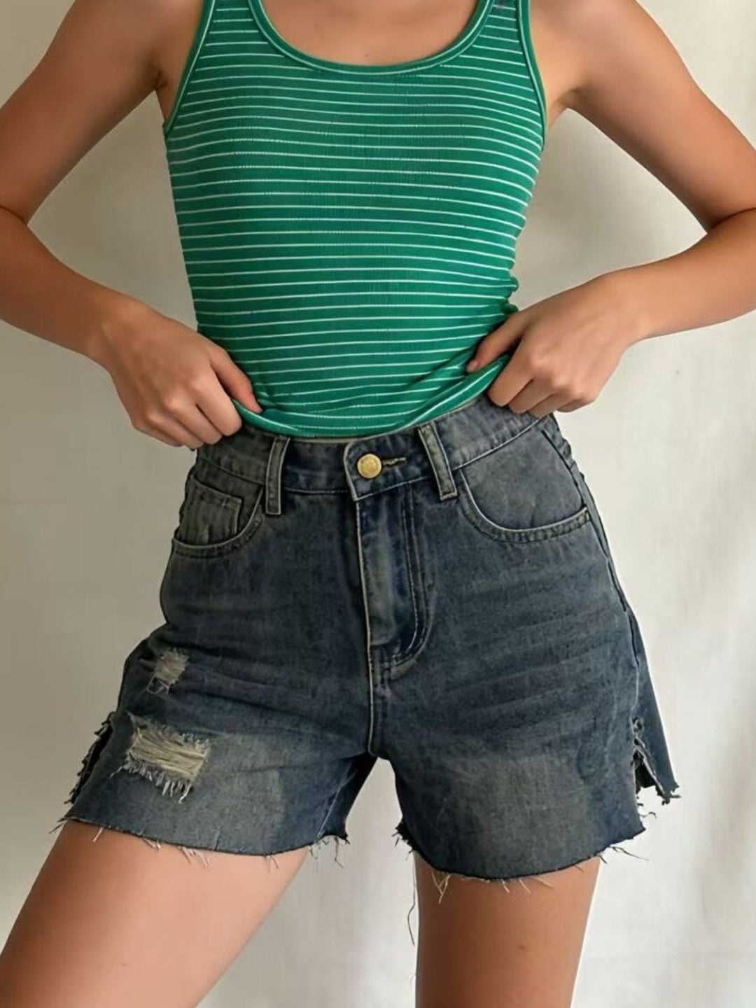 Distressed high-rise denim shorts with frayed raw hem