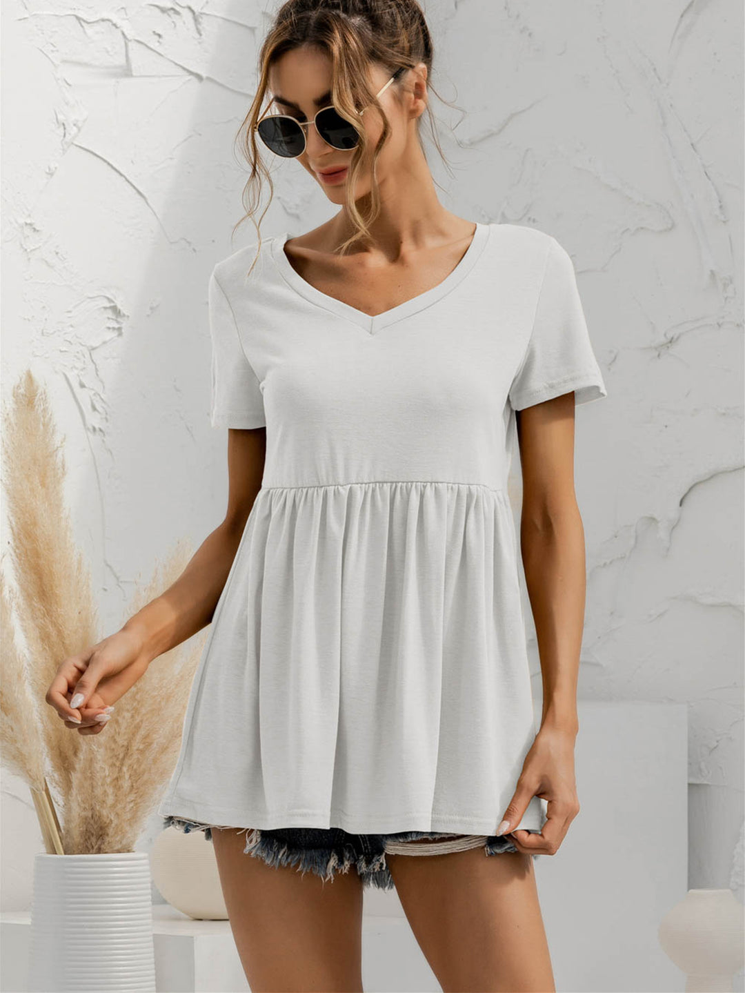 V-neck babydoll top with short sleeves and empire waist