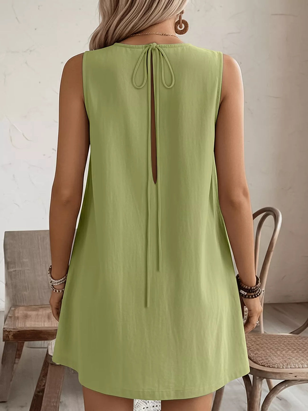 Ruffle-trim sleeveless mini dress with side pockets
