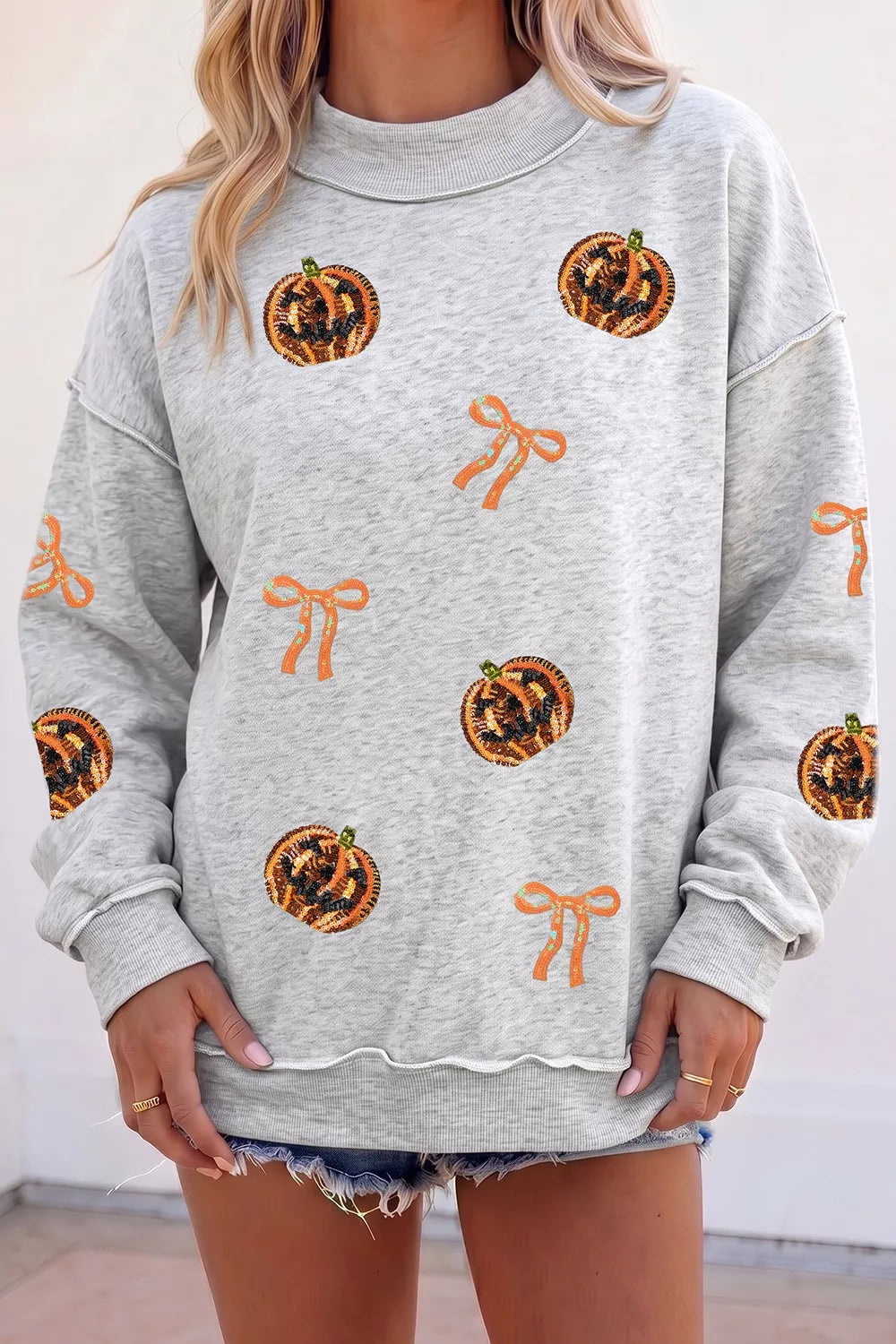 Sequin pumpkin and bow exposed seam Halloween sweatshirt