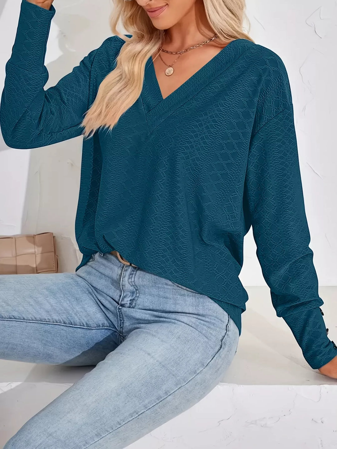 Plus size textured V-neck long sleeve top with button cuffs