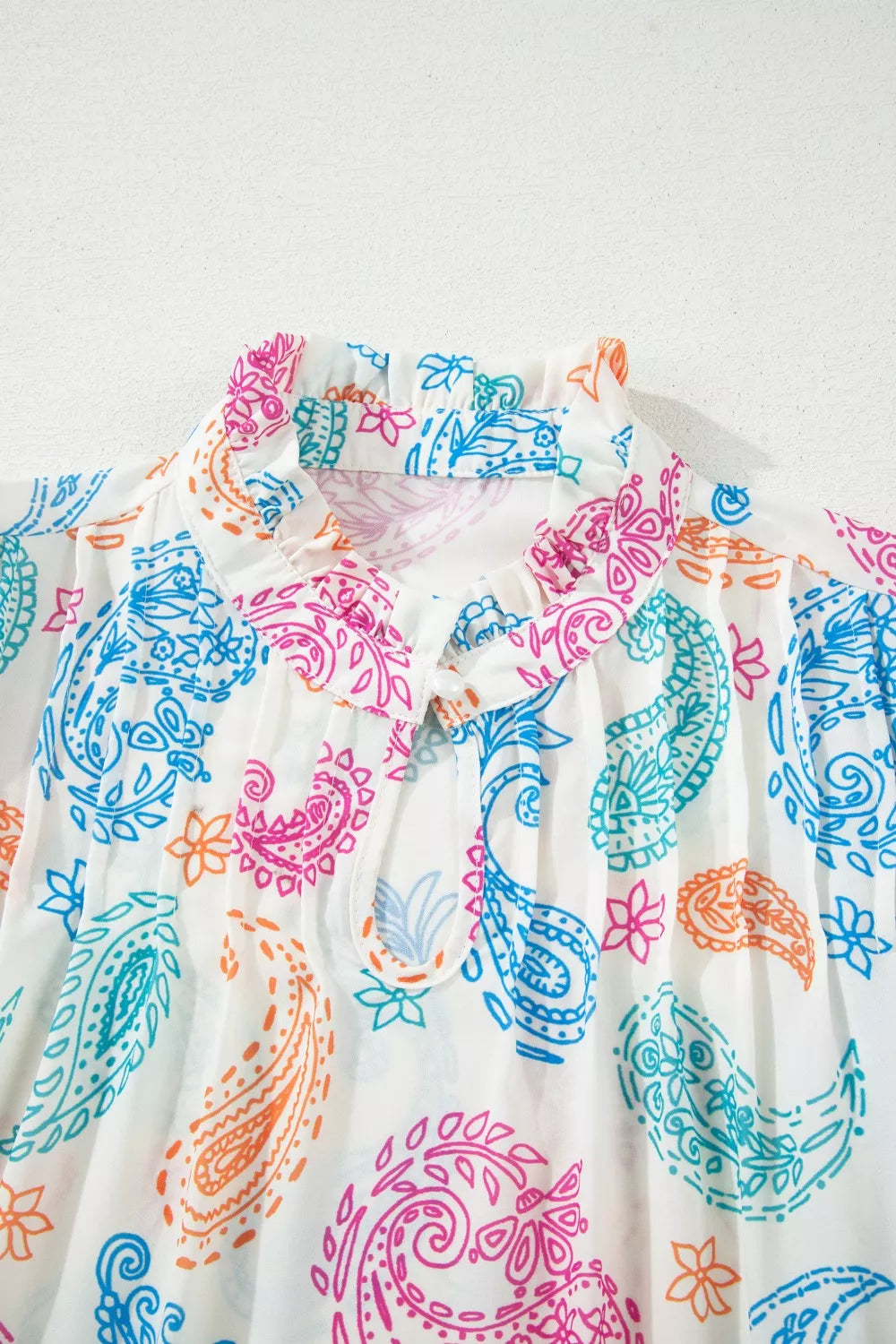 Paisley print keyhole blouse with ruffle neck and puff sleeves