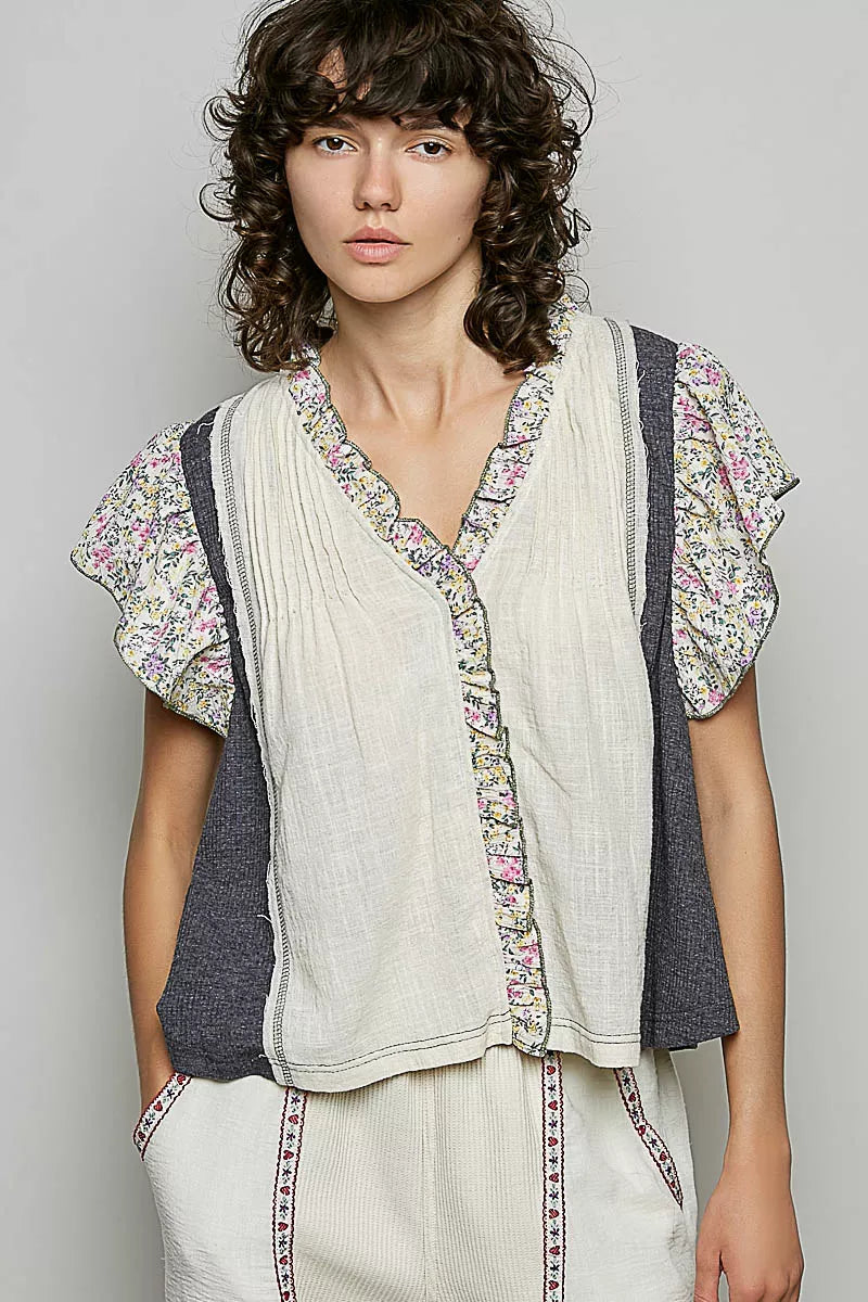 V-neck woven blouse with floral ruffle trim and pintuck front
