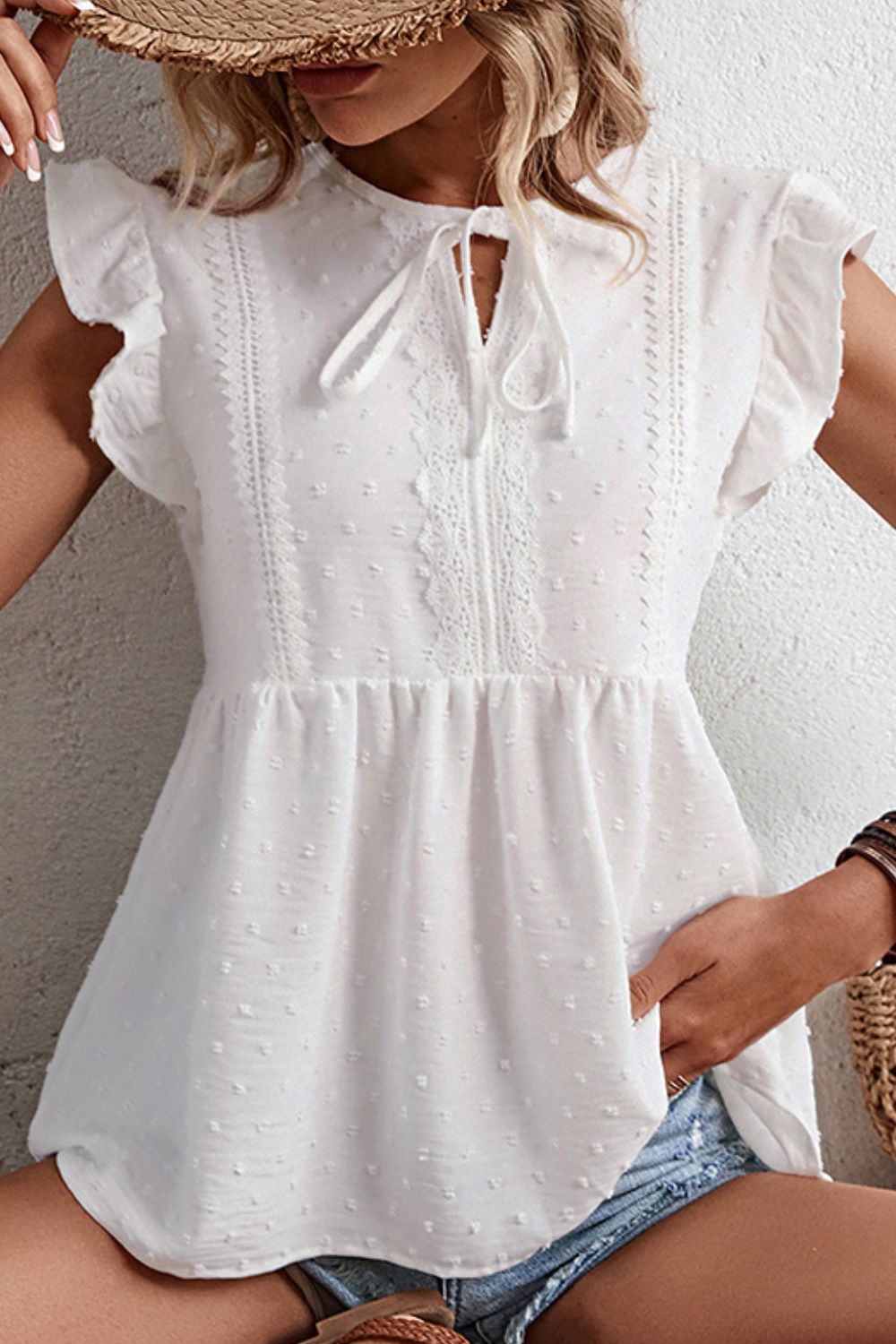 Swiss dot flutter sleeve peplum blouse with tie neck