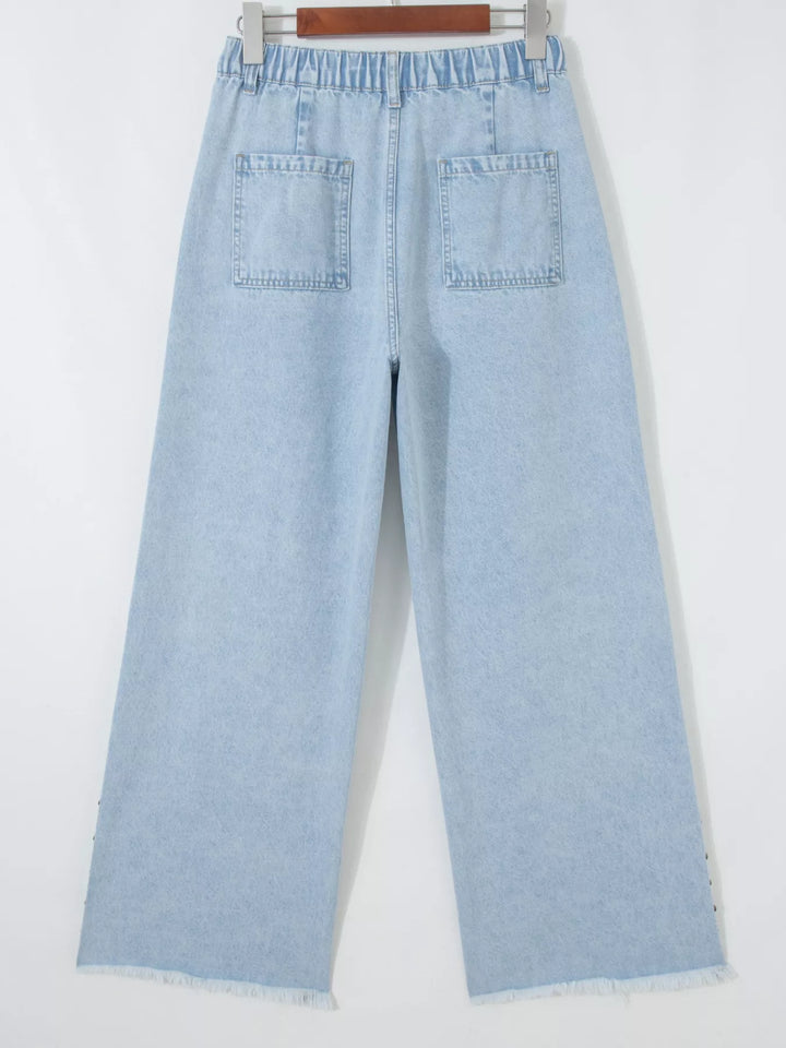 Studded wide leg jeans with side slits and frayed hem