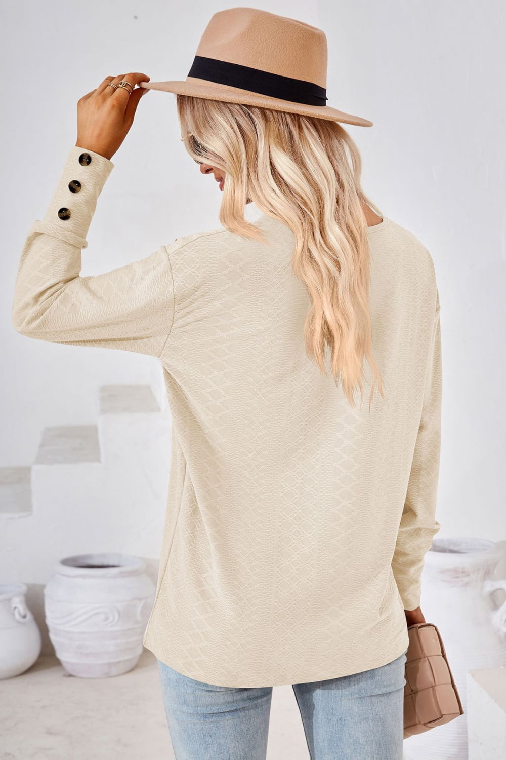 Textured knit V-neck long sleeve top with button cuffs