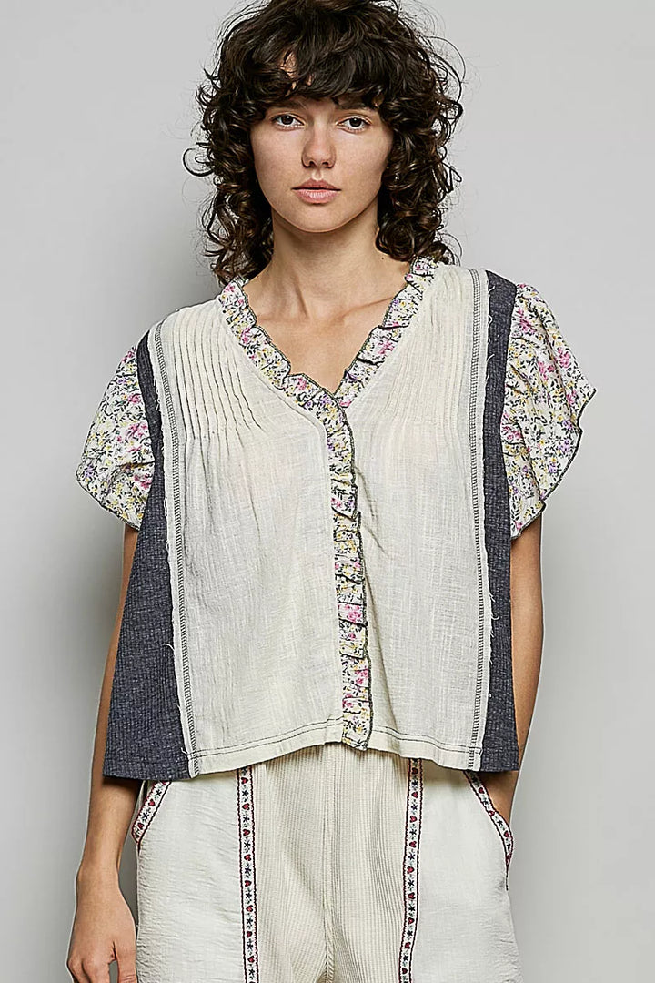 CREAM CHARCOAL V-neck woven blouse with floral ruffle trim and pintuck front