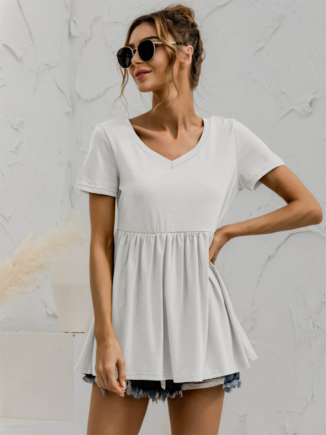 V-neck babydoll top with short sleeves and empire waist