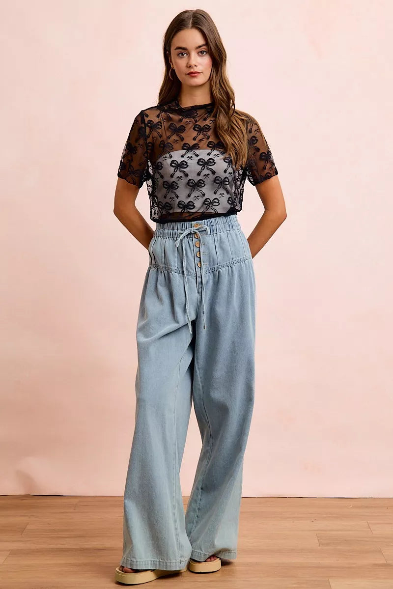 Sheer mesh mock-neck top with allover bow pattern